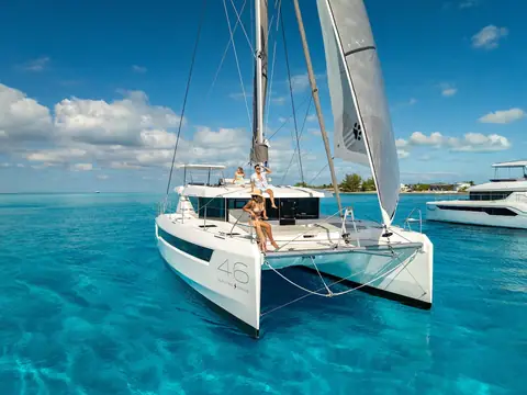 Leopard 46 at anchor seen from the bow with the 46 logo on the hull and guests forward
