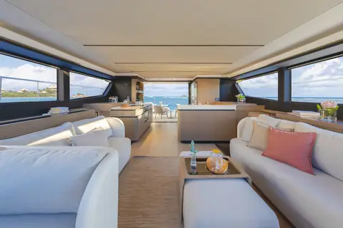 Leopard 53 Powercat saloon with white sofas, galley island and panoramic windows
