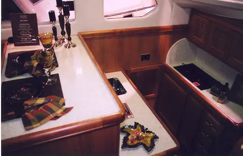 Mainship 34 Trawler galley with cherry cabinets and a solid surface counter