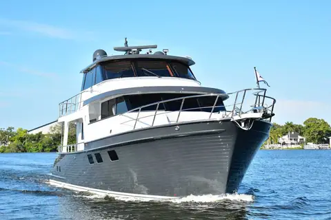 Marlow Explorer 58E seen from the bow quarter running, showing its flybridge and dark gray hull