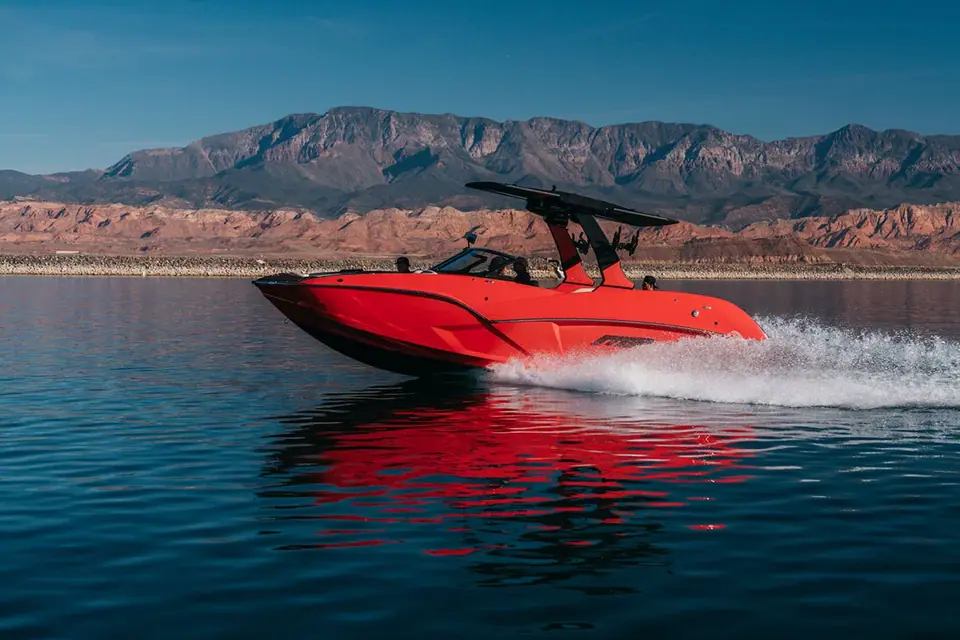 Red MB Sports B52 25 Alpha running fast across a desert lake with its tower and bimini up