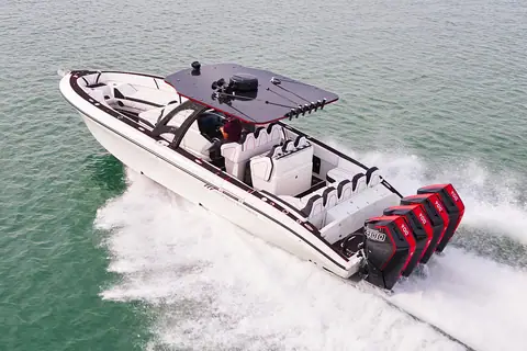 White Midnight Express 37 Open carving a turn with four red outboards