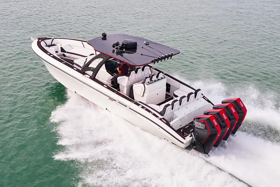 White Midnight Express 37 Open carving a turn with four red outboards