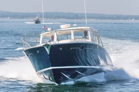 MJM 50z bow on at speed showing its Downeast sheer and hardtop