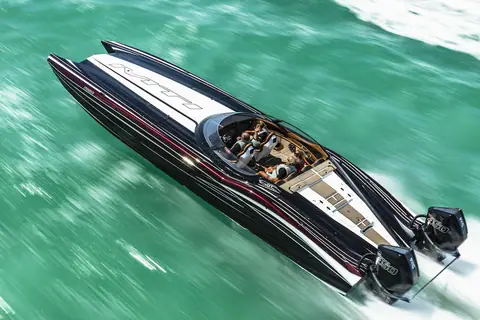 Black MTI 390X catamaran from above with crew in the cockpit and a sun pad aft