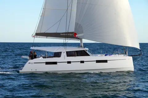 Nautitech 46 Open catamaran sailing under full main and genoa, seen from the port side