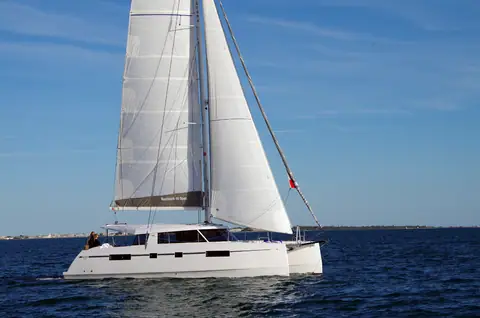 Nautitech 46 Open under main and genoa off a low coastline