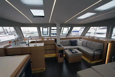 Nautitech 46 Open saloon with an L shaped settee, galley counter and wraparound windows
