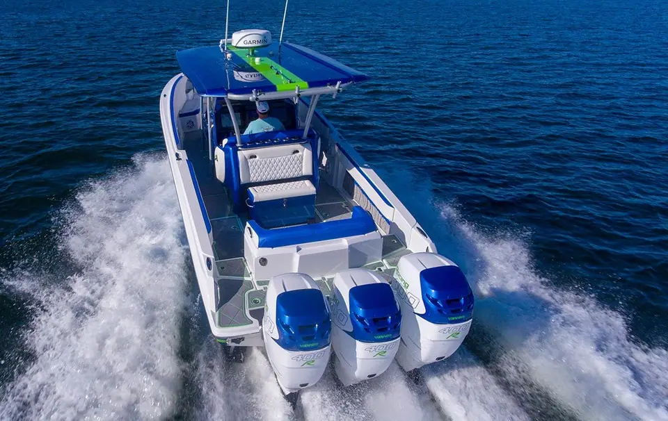 Nor Tech 340 Sport seen from astern at speed, showing the cockpit and triple outboards