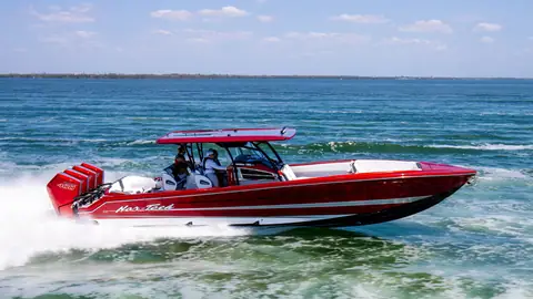 Red Nor Tech 390 Sport running at speed, seen from the port side