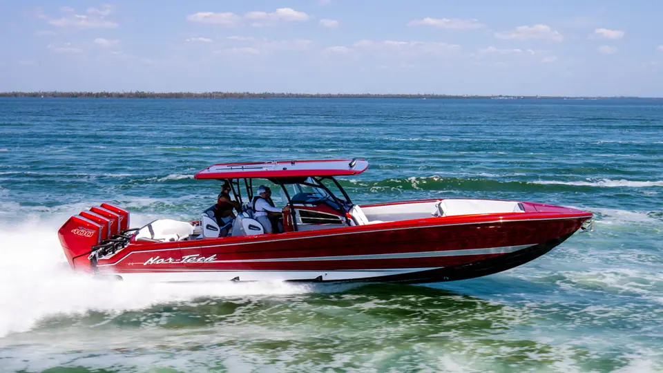 Red Nor Tech 390 Sport running at speed, seen from the port side