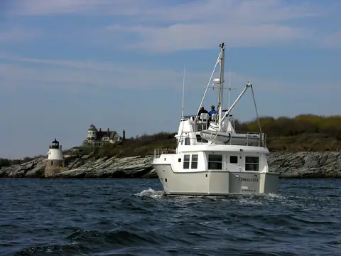 Nordhavn 40 running toward the camera with people on the flybridge