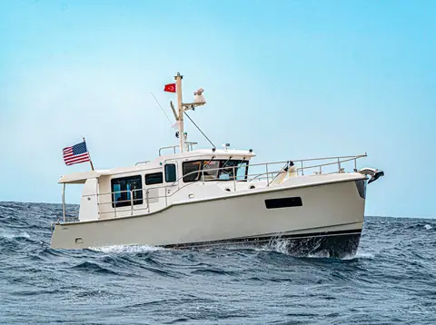 Nordhavn 41 underway from the port bow showing its pilothouse and mast