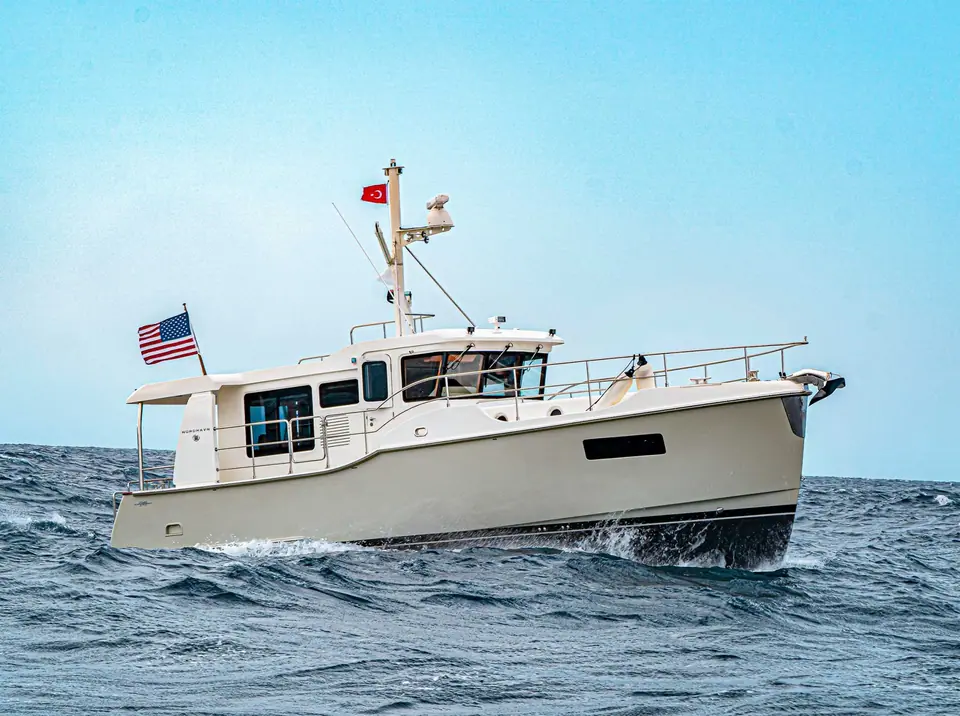 Nordhavn 41 underway from the port bow showing its pilothouse and mast