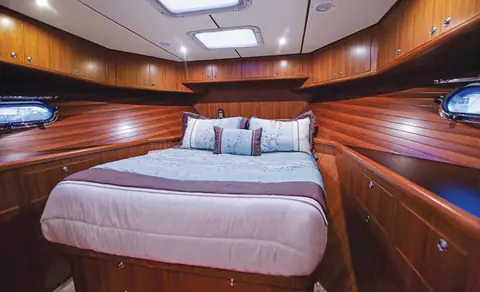Nordhavn 43 master stateroom with an island berth and cherry joinery