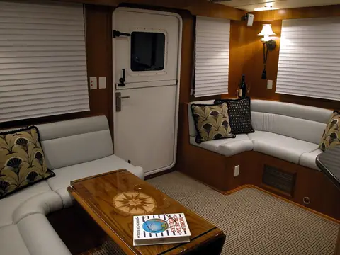 Nordhavn 47 salon with an L shaped settee, coffee table and aft door