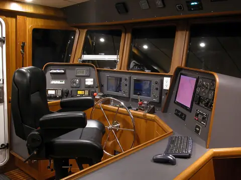 Nordhavn 47 pilothouse helm with a Stidd chair, wheel and electronics
