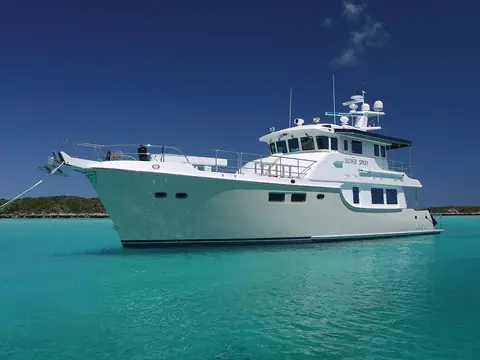 Nordhavn 63 at anchor in turquoise water, seen from the starboard bow