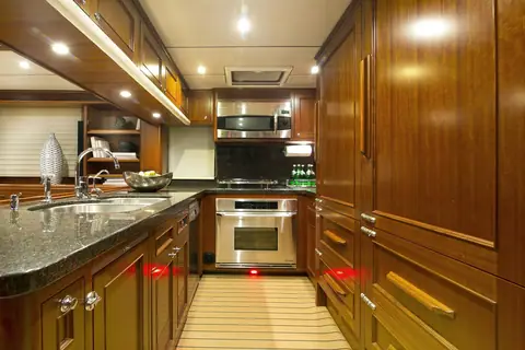 Nordhavn 63 galley with granite counters, stainless appliances and teak cabinets