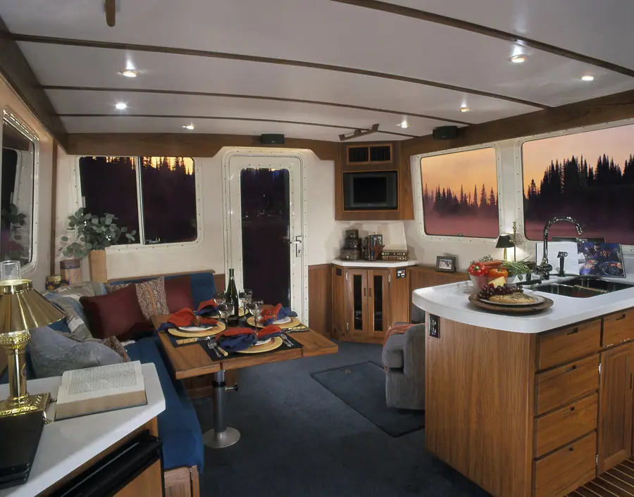 Nordic Tug 42 saloon with dinette, galley island and teak joinery