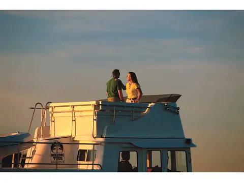 Nordic Tug 42 flybridge at sunset with a couple standing at the rail