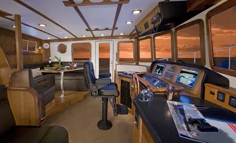 Nordic Tug 54 helm station with dinette and saloon seating visible aft