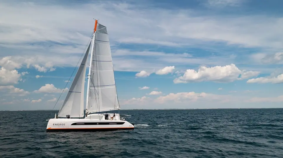 Outremer 51 sailing upwind in profile under a blue sky