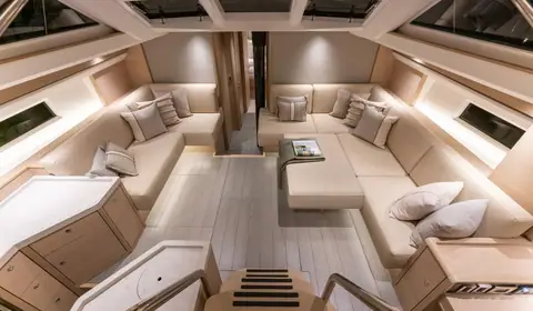 Oyster 495 deck saloon with facing settees, pale oak joinery and hull windows