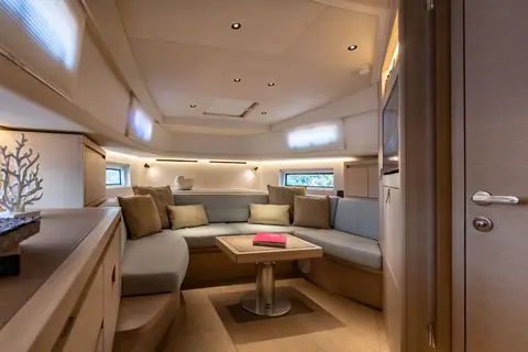 Pardo 43 cabin with U shaped settee, table and soft overhead lighting