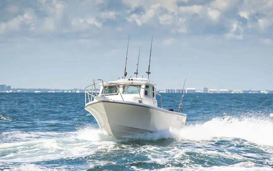 Parker 2320 Sport Cabin running toward the camera with a white wake