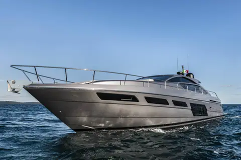 Pershing 6X seen from the bow quarter cruising slowly on calm blue water