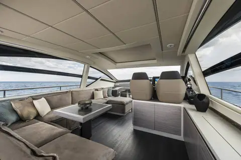 Pershing 6X main deck salon with gray sofa and wraparound windows