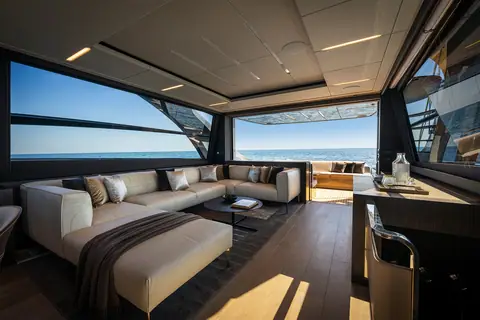Pershing 8X main deck salon with cream sofa and wide side windows