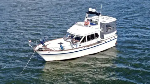 President 42 flybridge motor yacht from 1989 seen from above the bow quarter on open water
