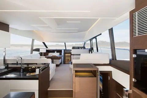 Prestige 520 main deck with the galley aft, saloon seating and the lower helm forward