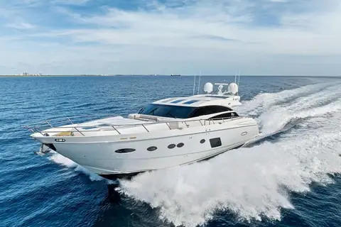 Princess 78 Motor Yacht running at speed with a big wake, seen from the bow quarter