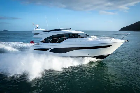 Princess F55 running at speed with a big wake, seen from the bow quarter