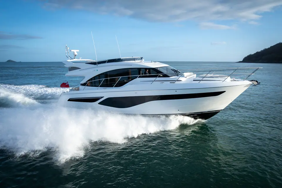 Princess F55 running at speed with a big wake, seen from the bow quarter