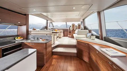 Princess F55 main deck with walnut galley aft and saloon seating leading to the helm
