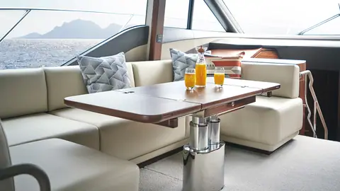 Princess F55 saloon dinette with cream leather seating and a folding walnut table