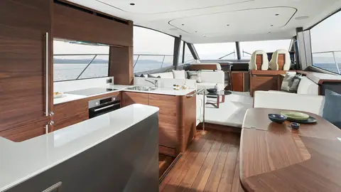 Princess F65 main deck with walnut galley aft and saloon seating forward
