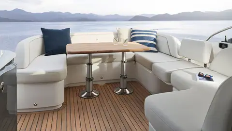 Princess V50 cockpit with a U shaped settee around a teak table