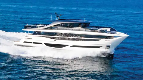 Princess X95 super flybridge yacht running at speed in profile