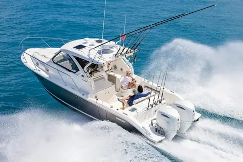 Pursuit OS 325 Offshore seen from the stern quarter at speed showing twin Yamaha outboards and cockpit