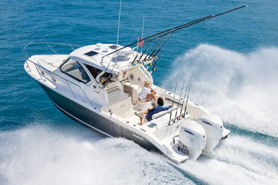 Pursuit OS 325 Offshore seen from the stern quarter at speed showing twin Yamaha outboards and cockpit