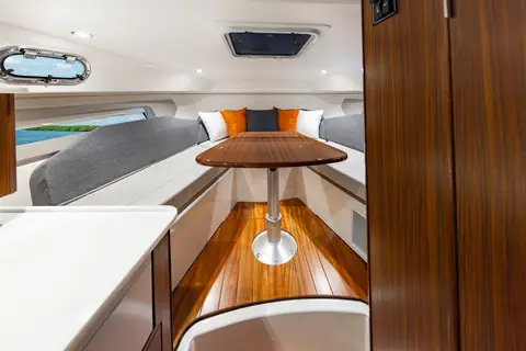 Pursuit OS 325 Offshore cabin with a dinette table that converts to a V berth