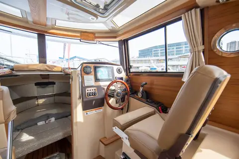 Ranger Tugs R-23 pilothouse helm with wheel, gauges and a leather helm seat