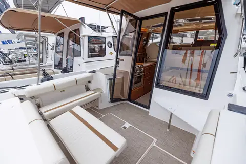 Ranger Tugs R-27 cockpit with bench seating and the open door into the pilothouse