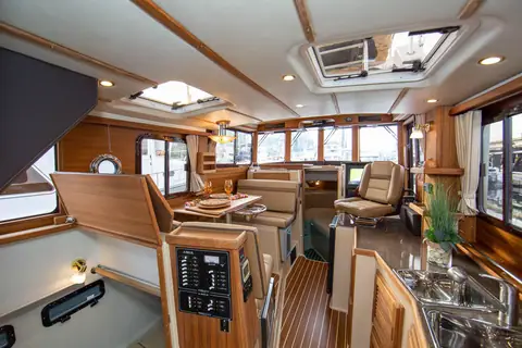 Ranger Tugs R-31 CB salon with teak joinery, galley, dinette and lower helm