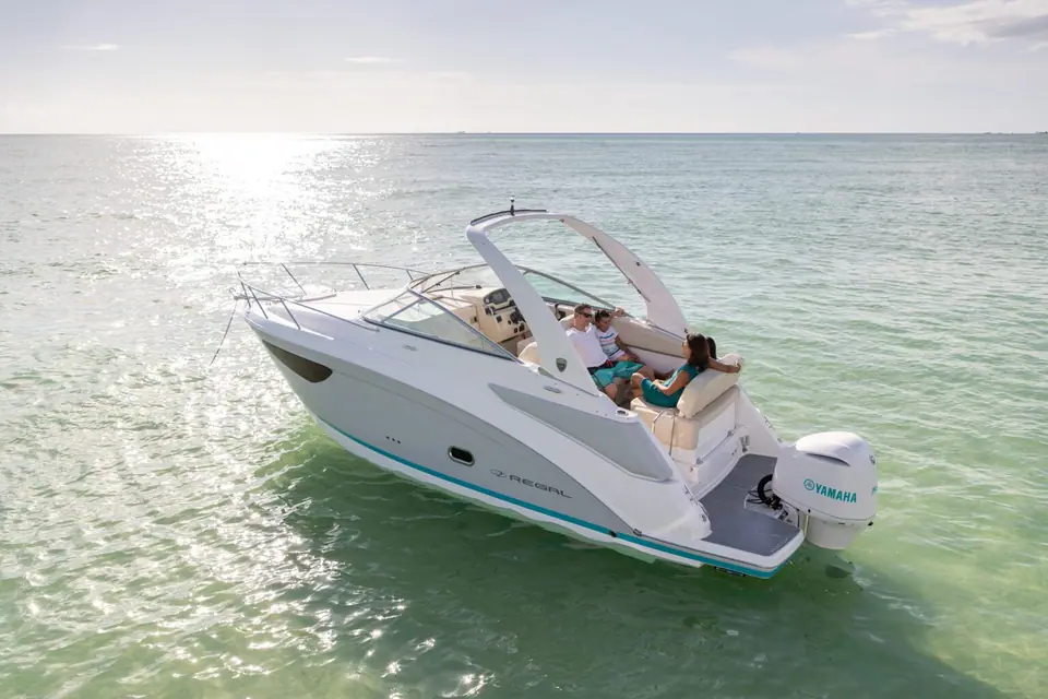 Regal 26 XO at rest in clear shallow water seen from the stern quarter
